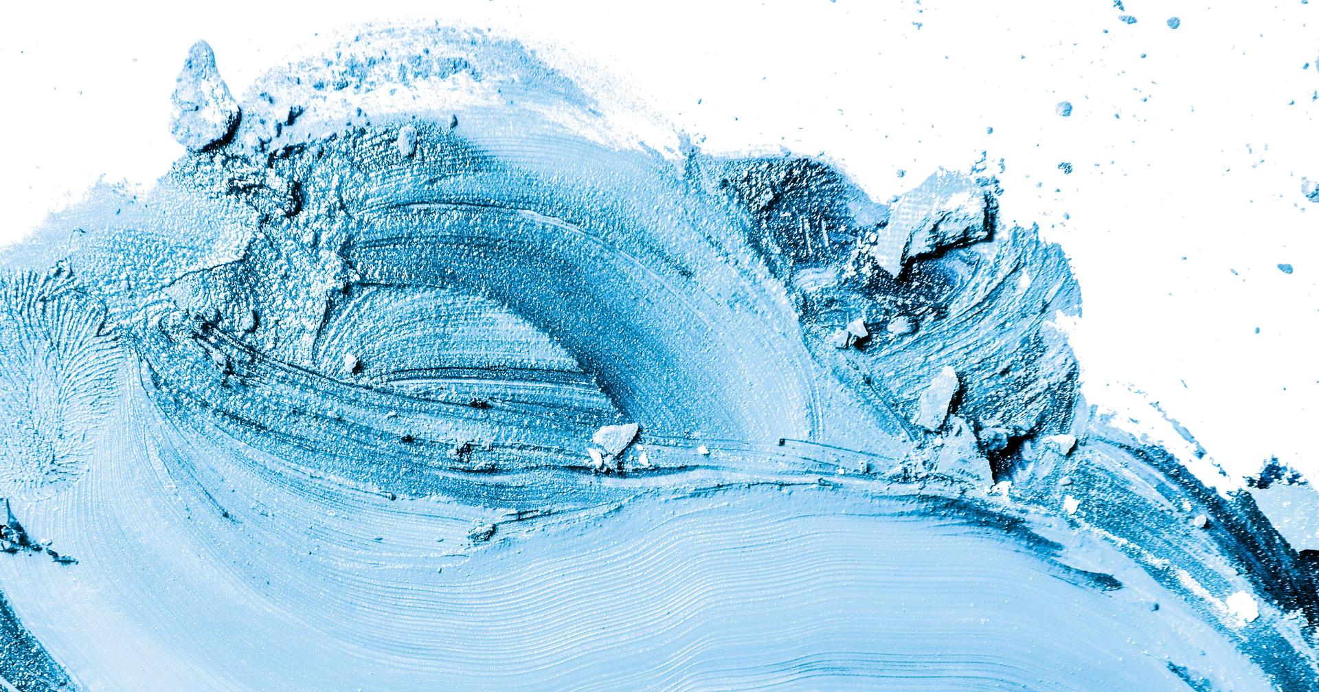 Artistic lipstick smudge and crushed eyeshadow as background