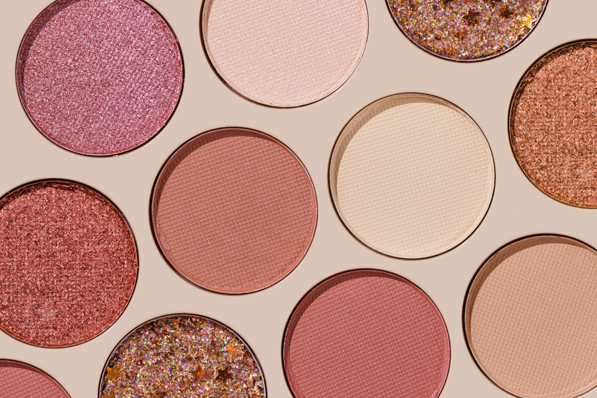 Cosmetics texture pattern, Warm vivid colored eye shadow makeup palette, round eye powder swatches. Female cosmetic and beauty products, aesthetic minimal beauty photo, colorful eyeshade, top view