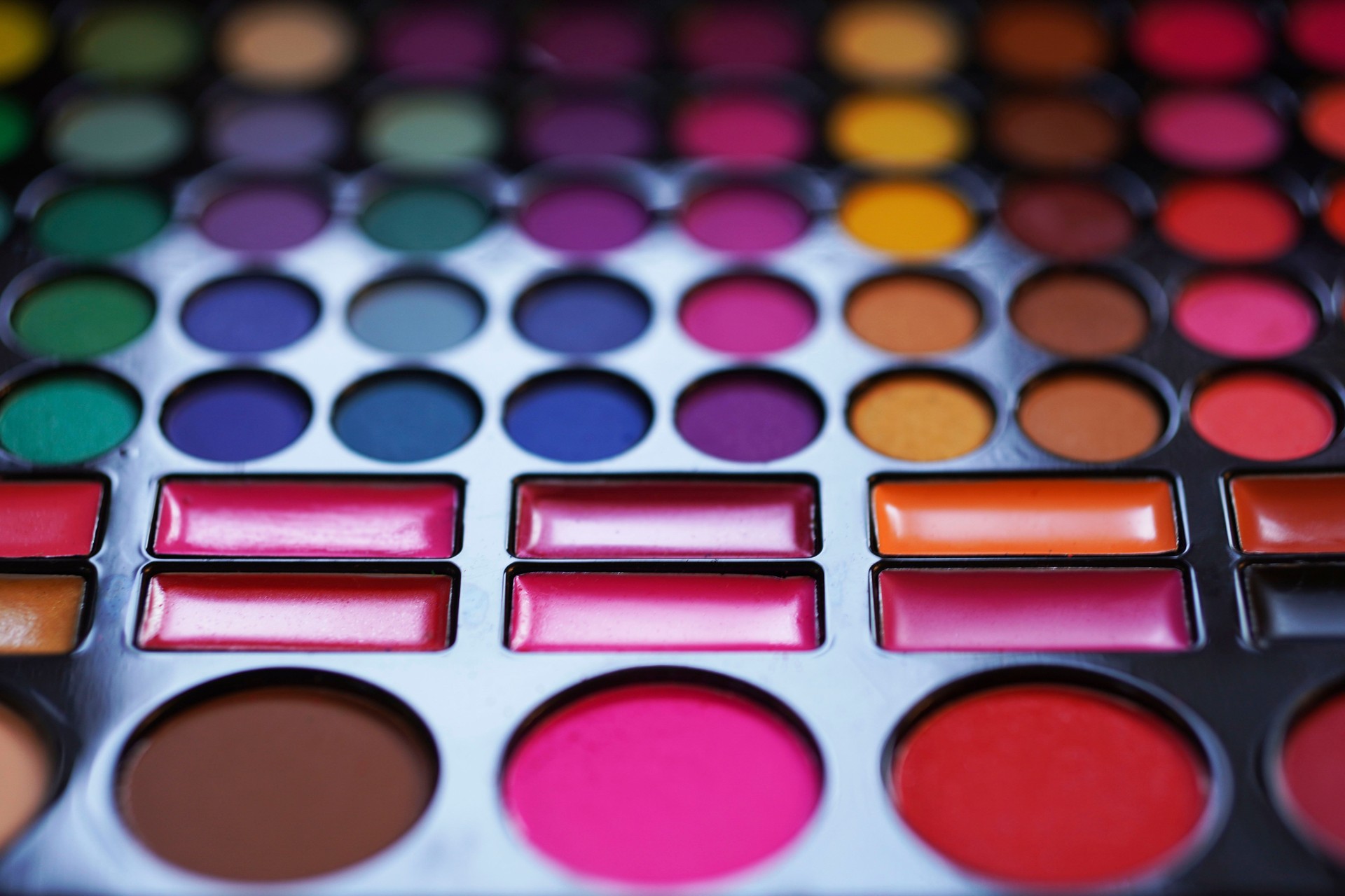 Makeup cosmetics set. Cosmetic beauty product. Beauty blogger concept. Make-up Eye Shadows, Blush, lipstick. Bright colors.